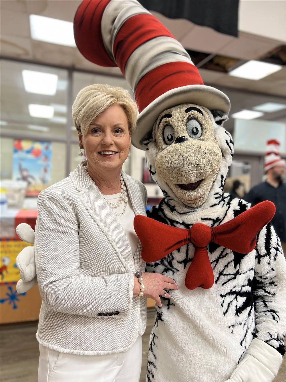 Executive Director of OIA, Becky Watson posing with the Cat in the Hat character.
